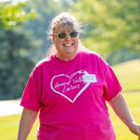 Angelique Dannenberg '92 walking on lawn around Carillon Tower